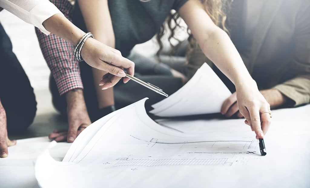 Watt Companies team reviewing blueprints